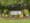 A sign surrounded by landscaping that reads "Pumpkin Ridge."